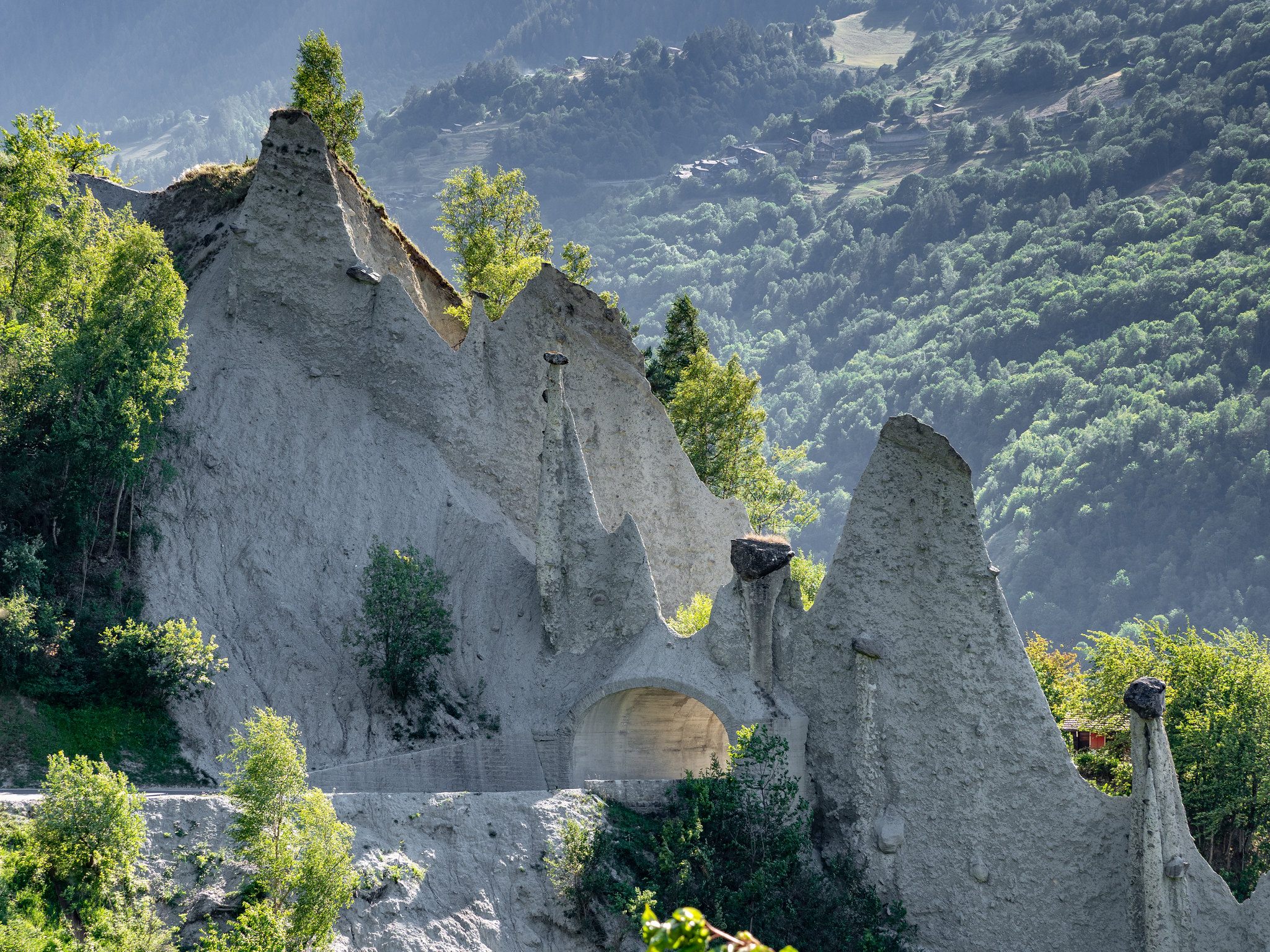 A tunnel allows a road to cut through the Pyramides d'Euseigne in Switzerland.