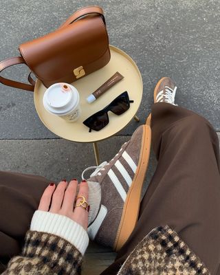 suede sneakers and brown pants