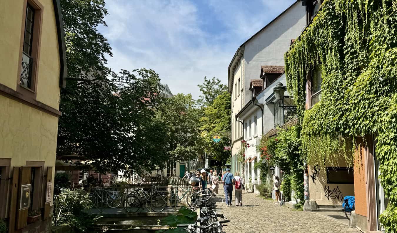 People exploring the quiet streets of Freiburg on a sunny day in Germany