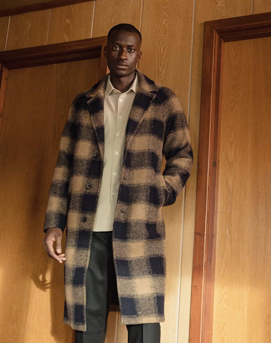 man wearing an overcoat and button up shirt