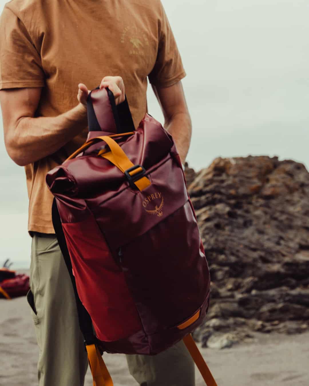 man lifting a weatherproof backpack