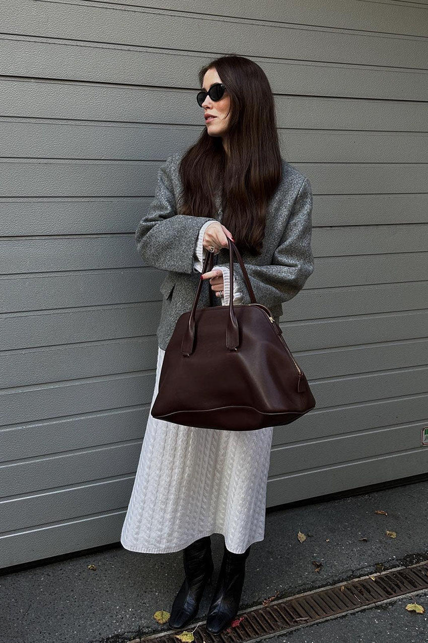 Woman wearing a knit dress and boots.