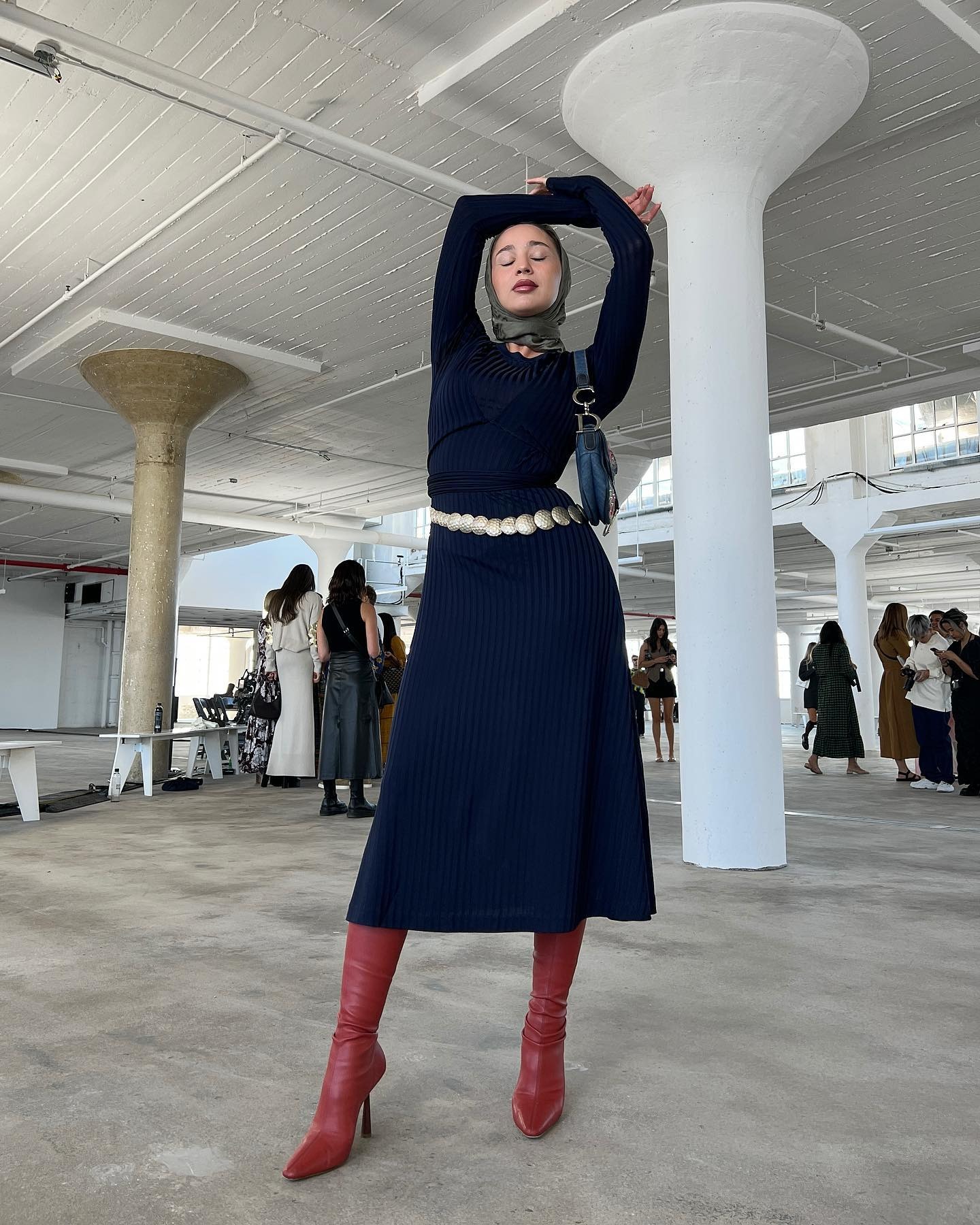 Woman wearing a knit dress and boots.